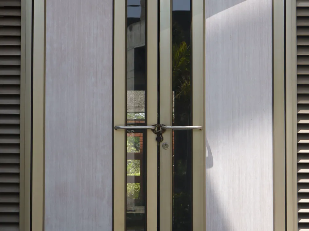 Pale front doors set into a stone building