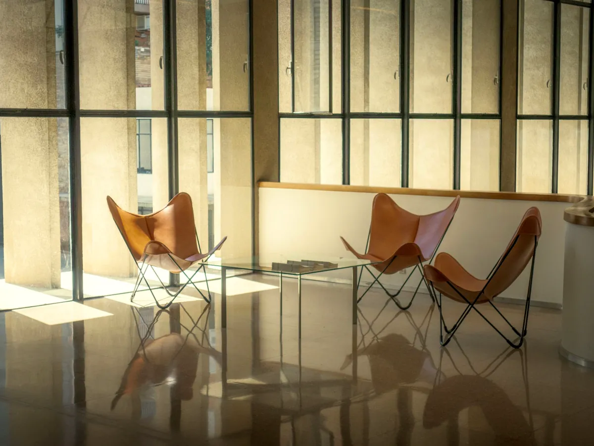 A quiet waiting area with chairs by tall windows