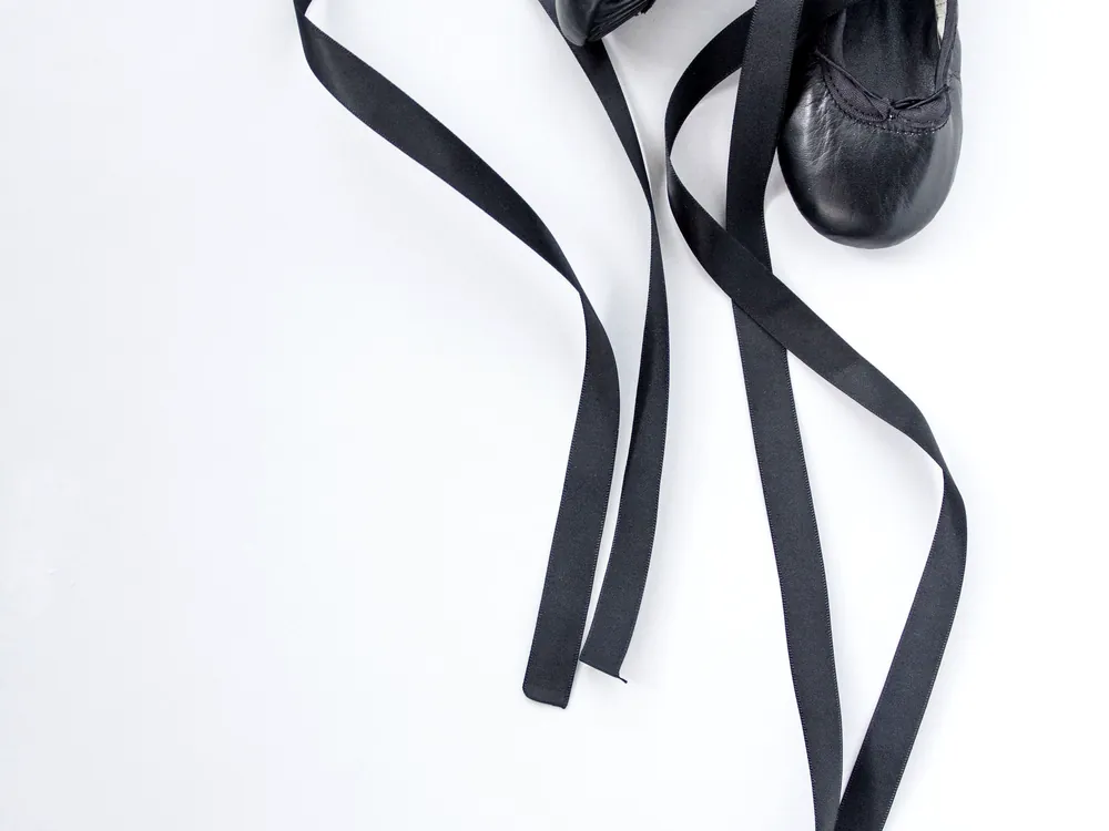 Black ballet slippers with loose ribbons