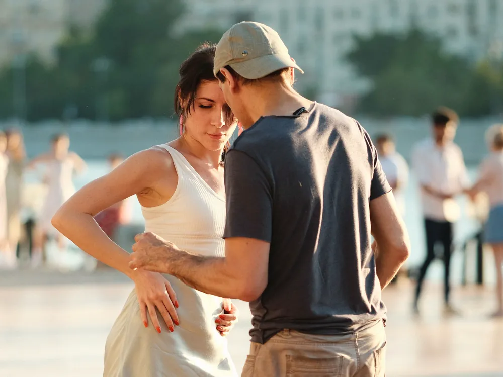 A couple in close hold on a wooden deck