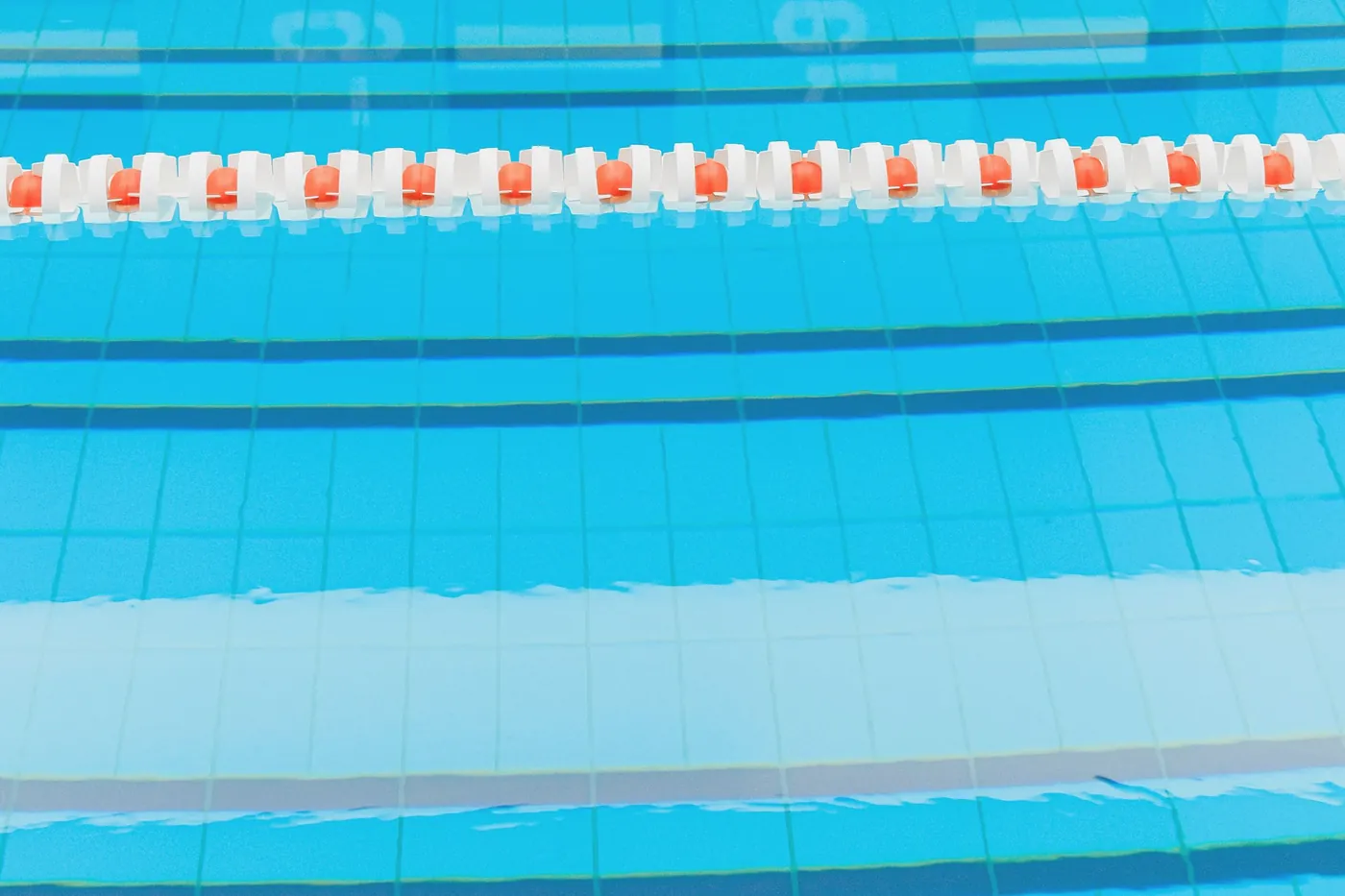 Lane ropes stretching down a clear pool
