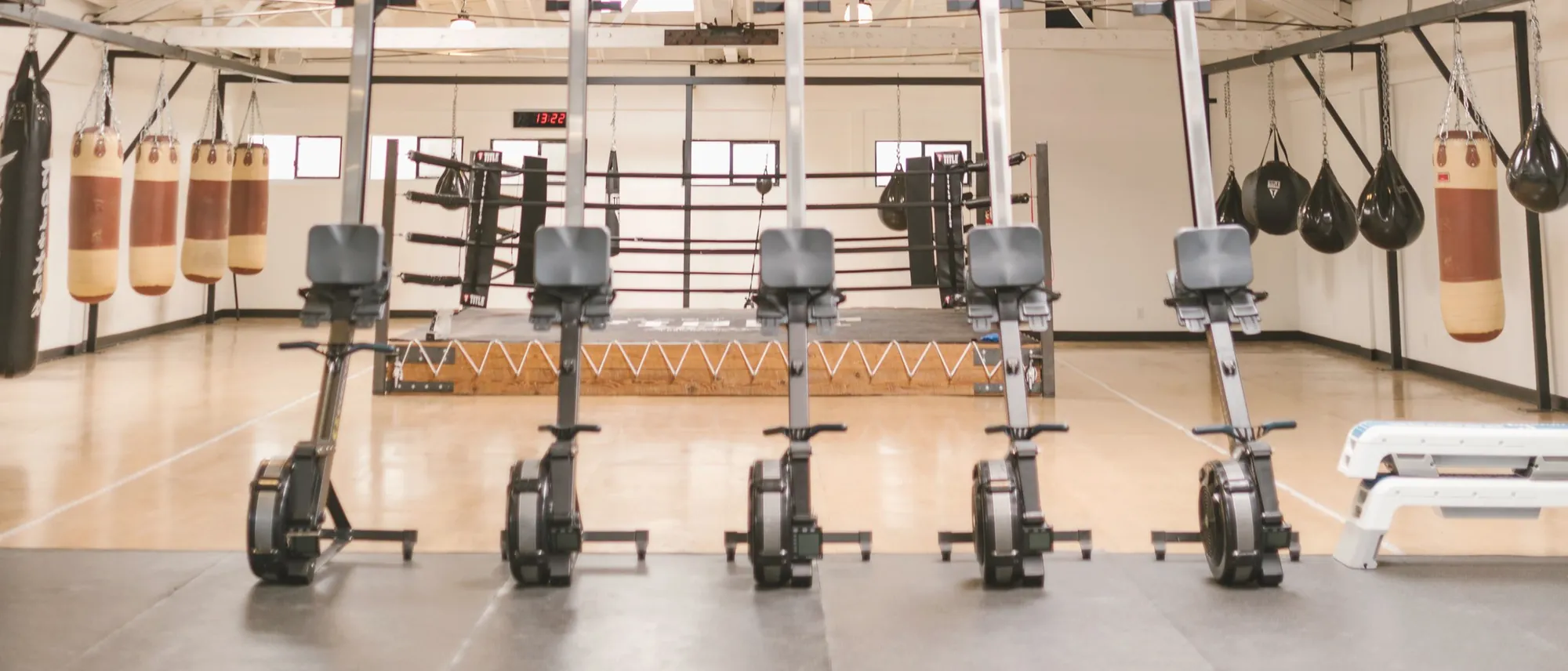 A wide empty training hall under a white roof truss