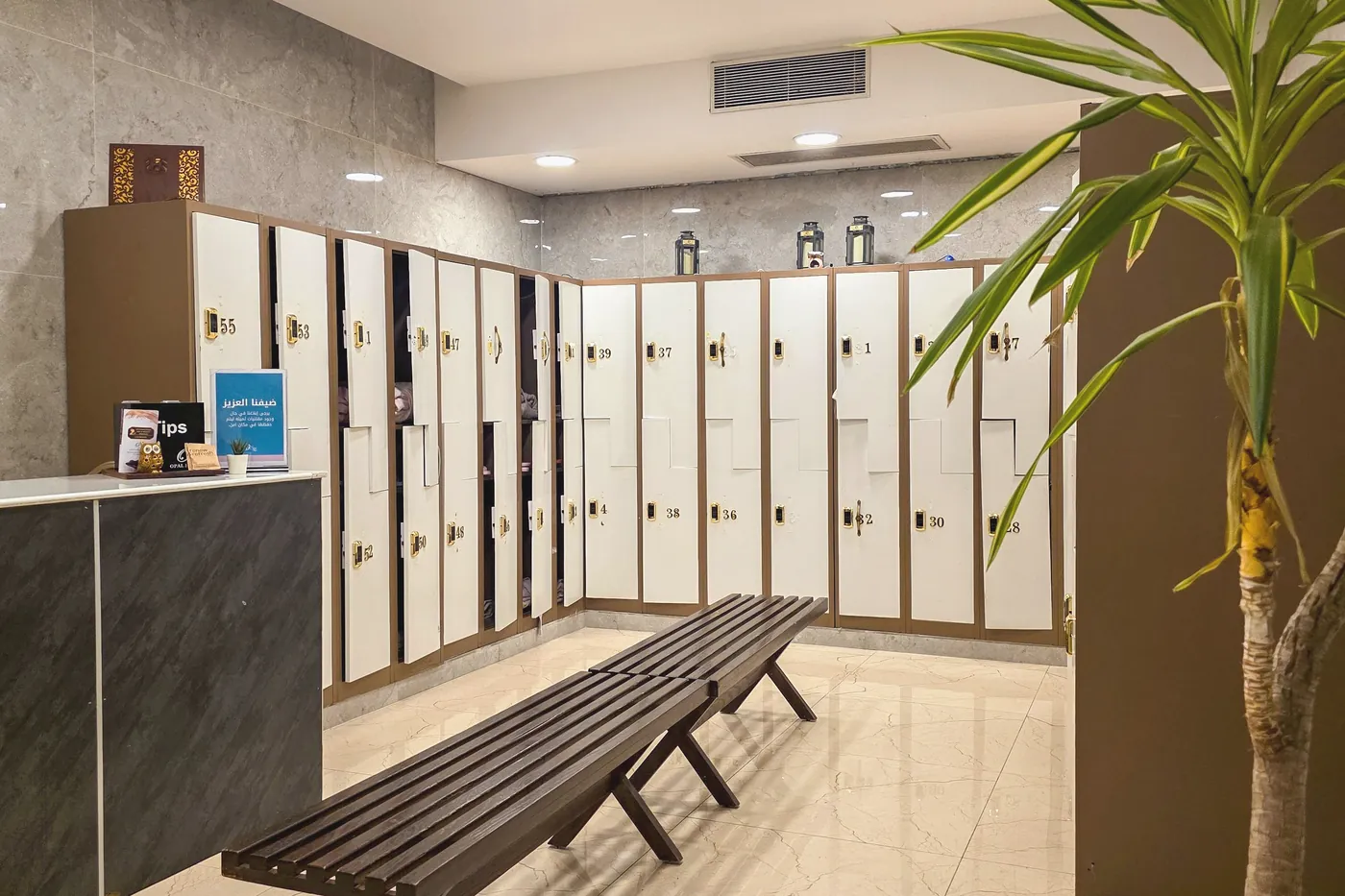 A changing room with lockers and a long bench