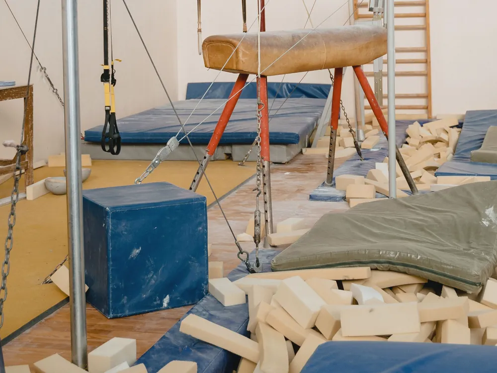 A foam pit beside blue mats