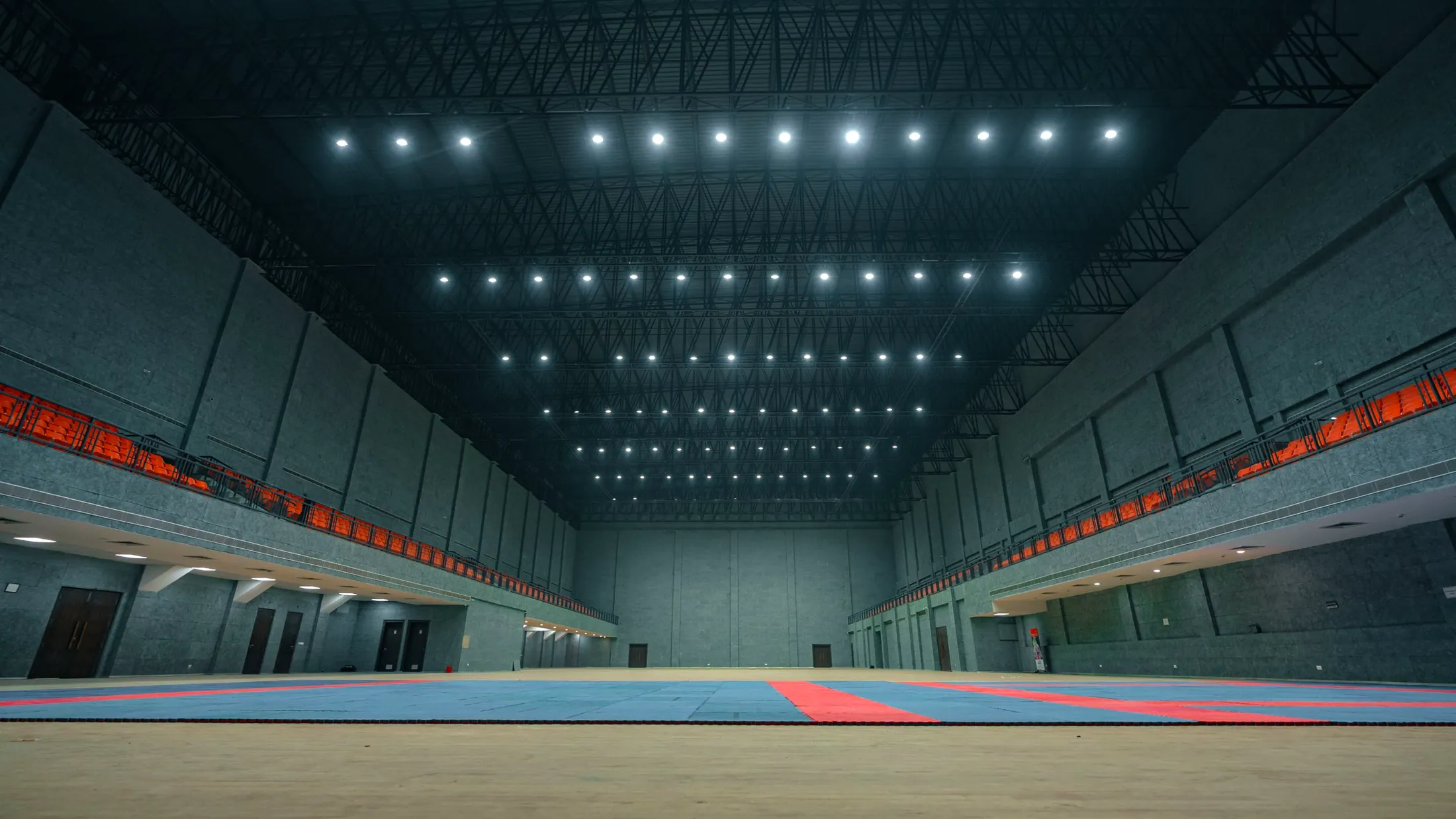 A long empty training hall under rows of lights