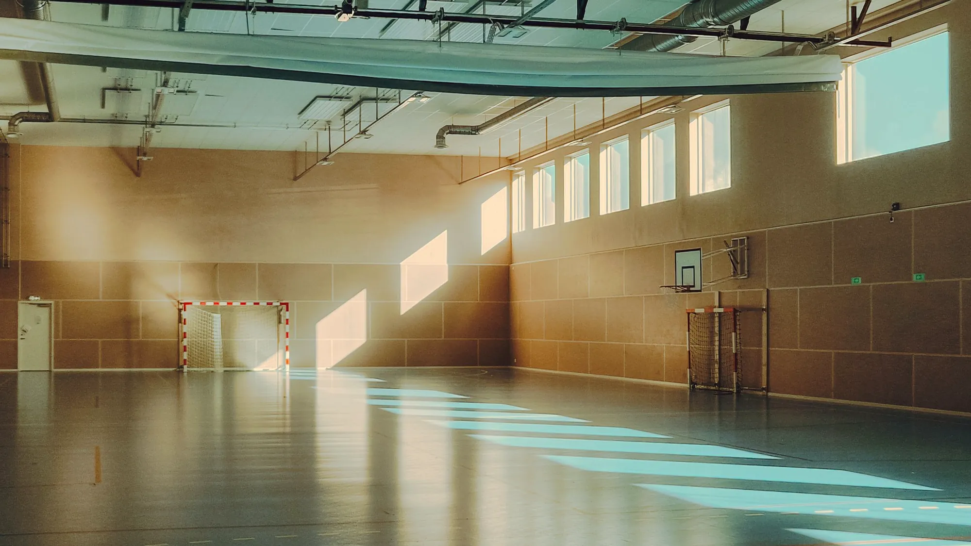 A wide hall with sunlight across the floor