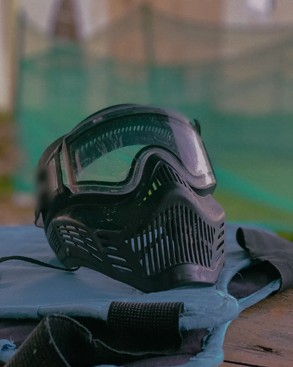 A paintball mask resting on a bench