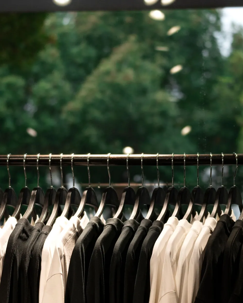 Plain shirts hanging on a rail, black and white