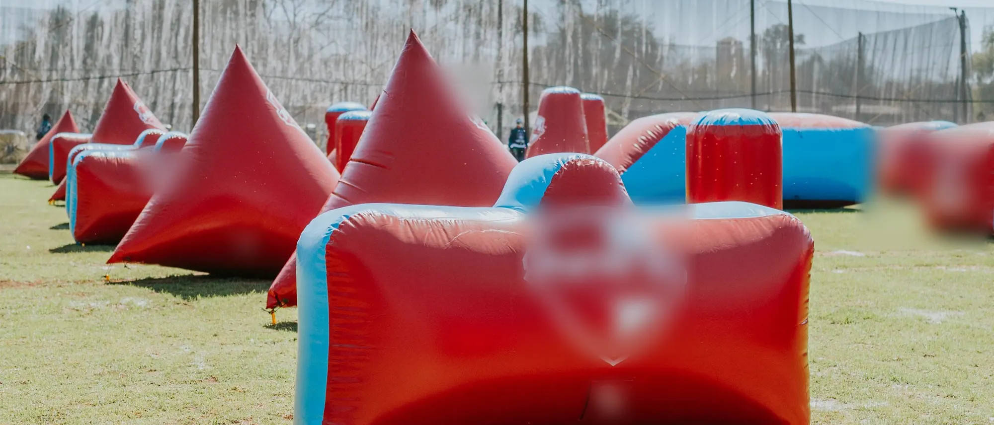 A low run of inflatable bunkers along the field, ground level