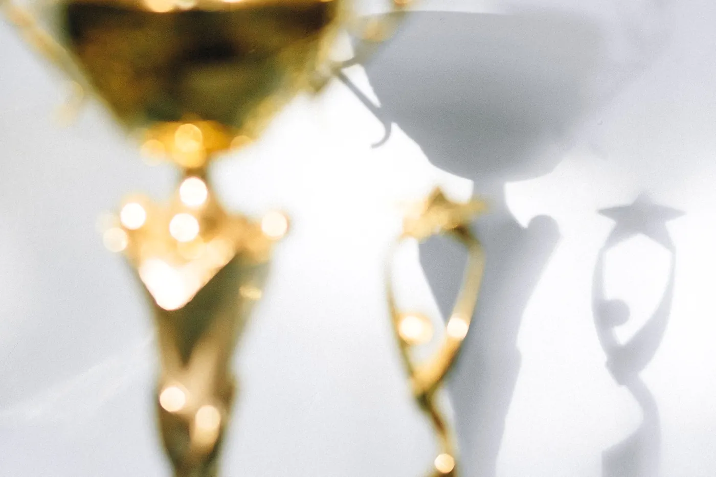 Gold trophies close up on a pale background