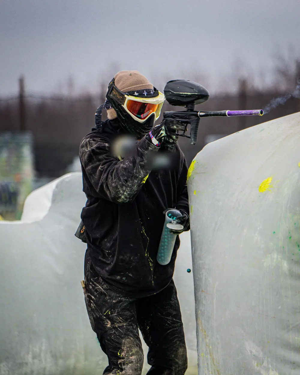 A single masked adult player, face fully covered, soft daylight